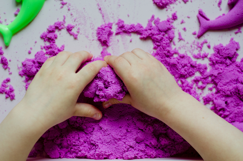 Girl preschooler sculpts kinesthetic sand at home. Developing activities for children. Art therapy. Psychological therapy for children.